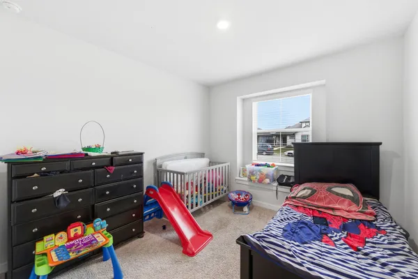 a bedroom with furniture and a wooden floor