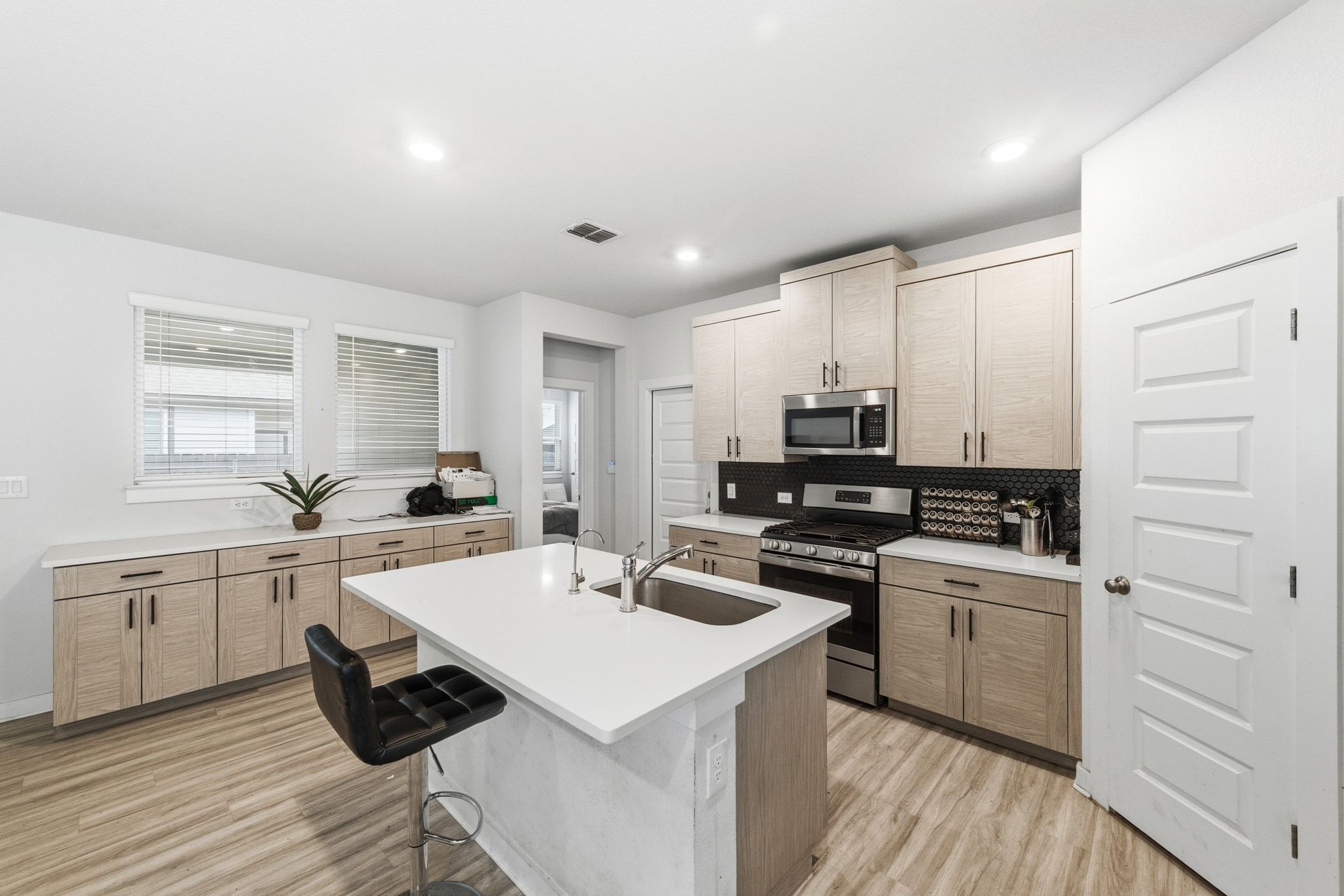 241 Banff Drive Kyle, TX 78640 - Photo 2 of 28 a kitchen with a sink stove and cabinets