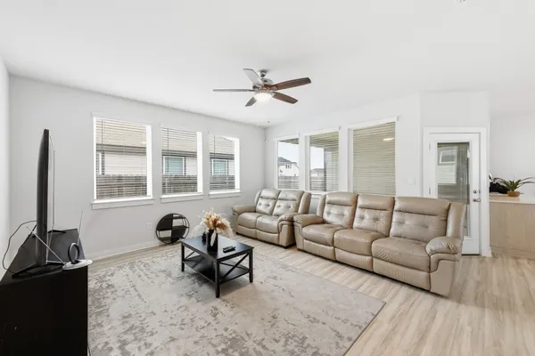 a living room with furniture window and a flat screen tv