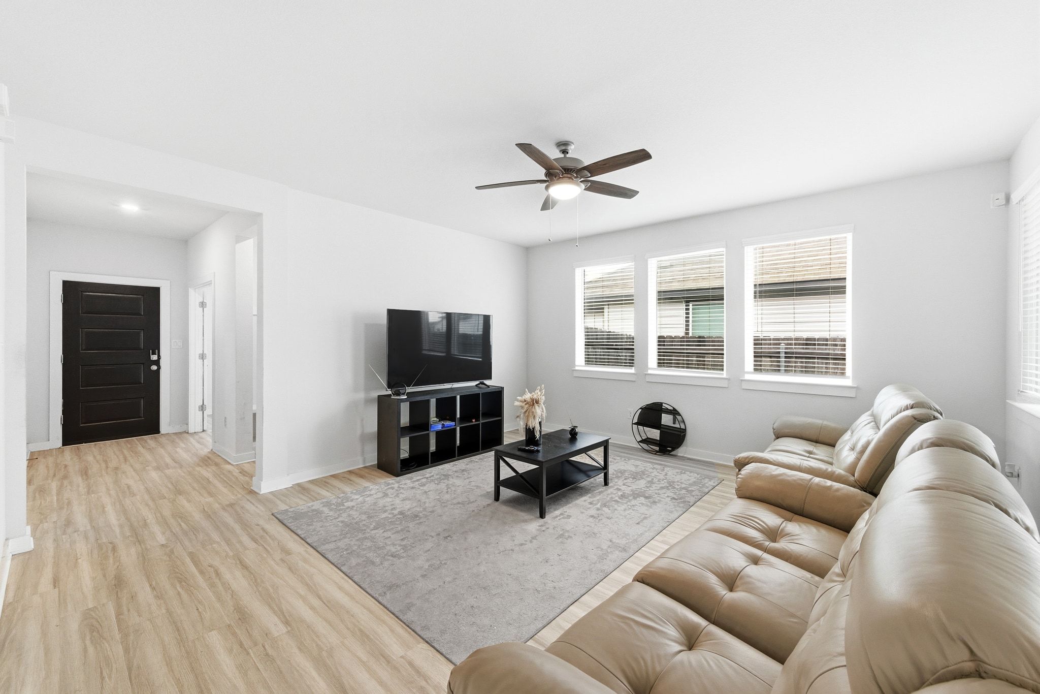241 Banff Drive Kyle, TX 78640 - Photo 5 of 28 a living room with furniture a window and a flat screen tv