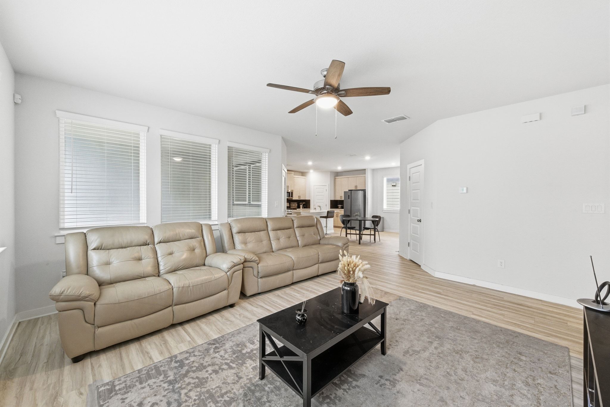 241 Banff Drive Kyle, TX 78640 - Photo 6 of 28 a living room with furniture and a ceiling fan