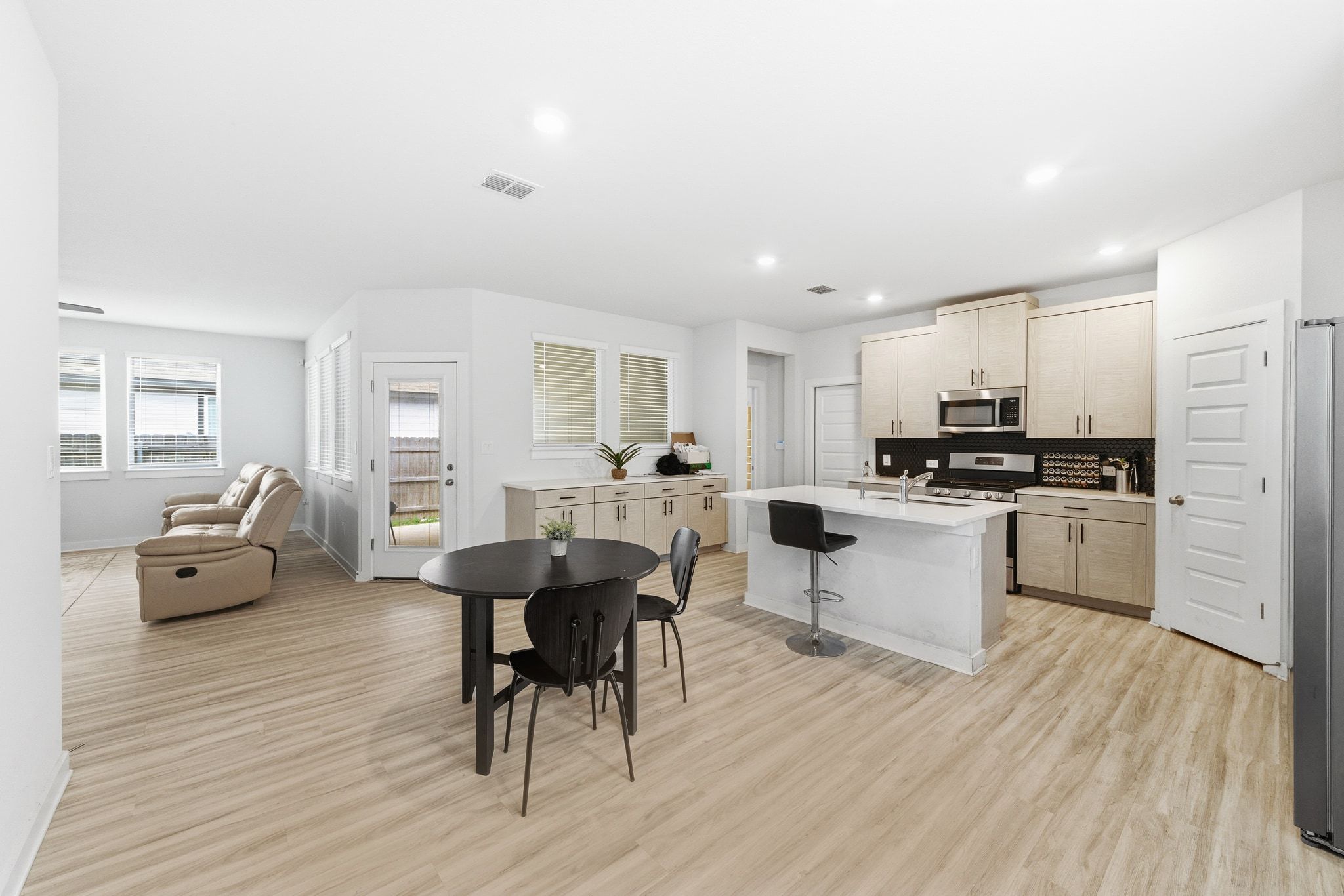 241 Banff Drive Kyle, TX 78640 - Photo 7 of 28 a kitchen with white cabinets and stainless steel appliances