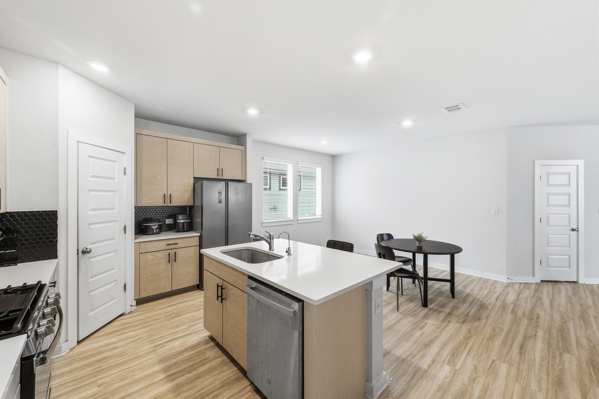 241 Banff Drive Kyle, TX 78640 - Photo 10 of 28 a kitchen with a sink a counter top space stainless steel appliances and cabinets