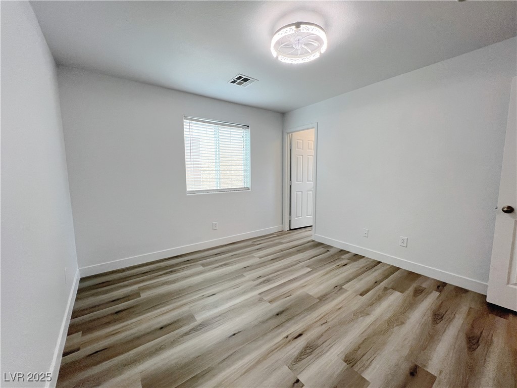 8821 Steaming Thunder Court Las Vegas, NV 89148 - Photo 16 of 31 Unfurnished bedroom featuring light wood-type flooring and baseboards
