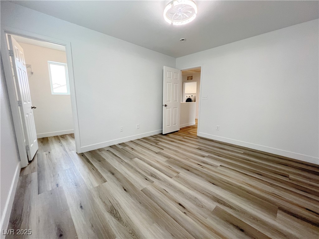 8821 Steaming Thunder Court Las Vegas, NV 89148 - Photo 18 of 31 Unfurnished room featuring light wood-style flooring and baseboards
