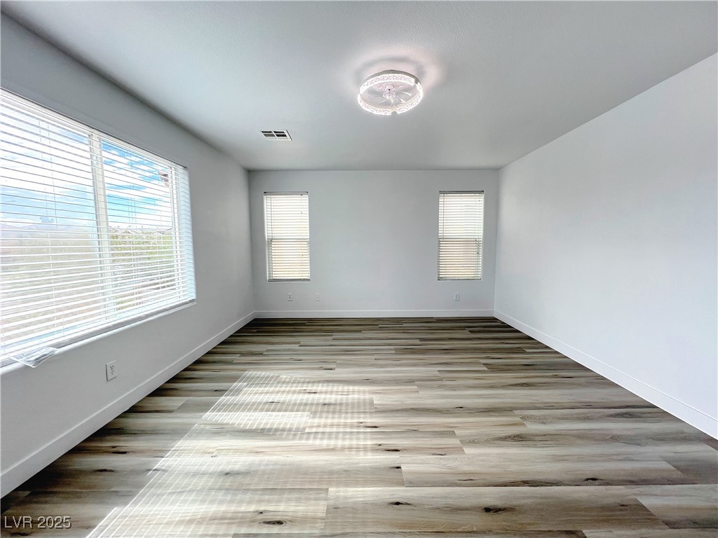 8821 Steaming Thunder Court Las Vegas, NV 89148 - Photo 23 of 31 Spare room with light wood-type flooring and baseboards