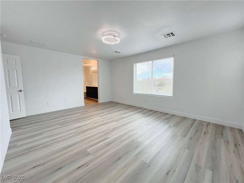 8821 Steaming Thunder Court Las Vegas, NV 89148 - Photo 24 of 31 Spare room with light wood-style flooring