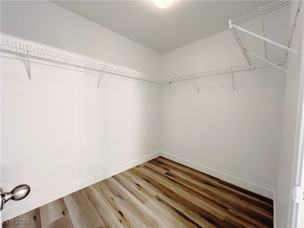 8821 Steaming Thunder Court Las Vegas, NV 89148 - Photo 28 of 31 Spacious closet with wood finished floors