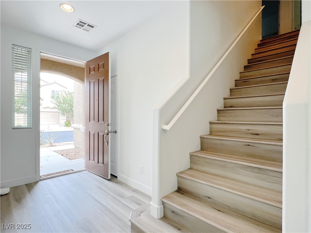 8821 Steaming Thunder Court Las Vegas, NV 89148 - Photo 3 of 31 Entryway with stairway, light wood-type flooring, and recessed lighting