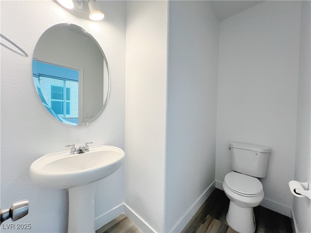 8821 Steaming Thunder Court Las Vegas, NV 89148 - Photo 5 of 31 Bathroom featuring wood finished floors and a textured wall