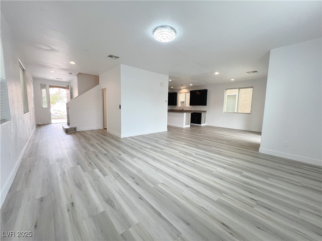 8821 Steaming Thunder Court Las Vegas, NV 89148 - Photo 6 of 31 Unfurnished living room featuring light wood-style flooring and recessed lighting