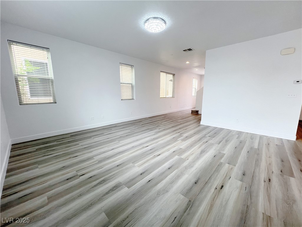 8821 Steaming Thunder Court Las Vegas, NV 89148 - Photo 7 of 31 Unfurnished room with light wood-style floors
