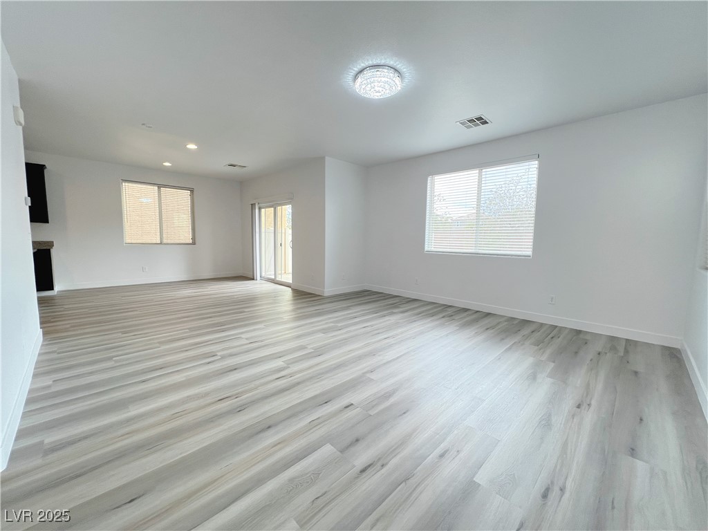 8821 Steaming Thunder Court Las Vegas, NV 89148 - Photo 8 of 31 Unfurnished room with light wood-style floors, healthy amount of natural light, and recessed lighting
