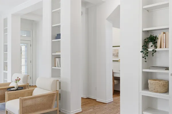 a dining room with furniture window and wooden floor