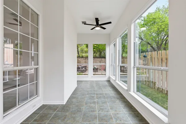 an empty room with a empty space and windows