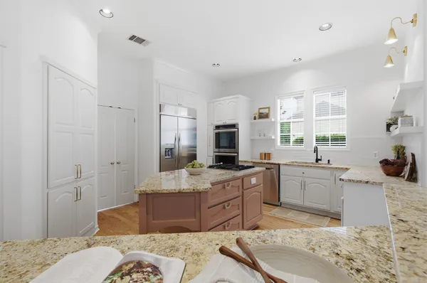 a kitchen with a sink and a wooden floor