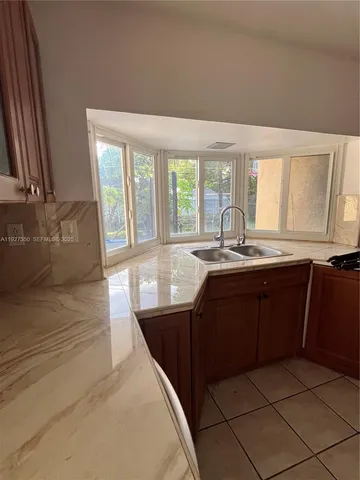 a kitchen with a sink and large window