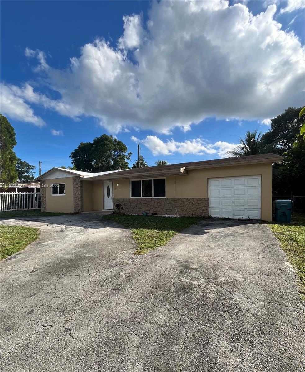 150 Northeast 173rd Street Miami, FL 33162 - Photo 4 of 10 a view of a house with a yard