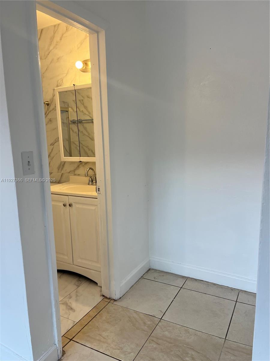 150 Northeast 173rd Street Miami, FL 33162 - Photo 8 of 10 a view of an empty room and window