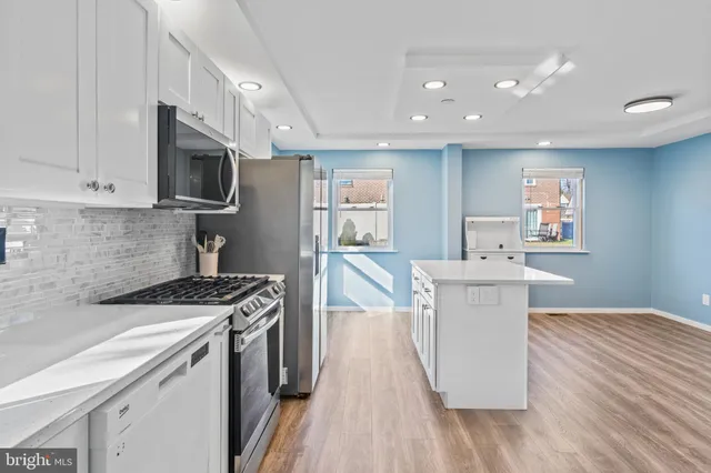 a kitchen that has a sink and a stove top oven