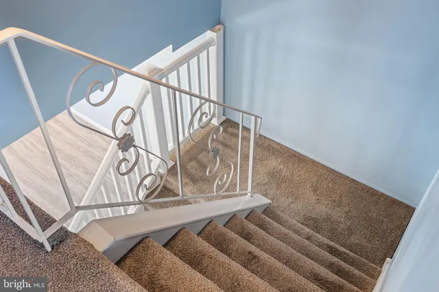 a view of a hallway with closet and wooden floor