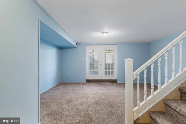 an empty room with a fireplace and a window