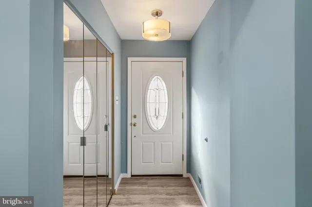 a view of an entryway with wooden floor