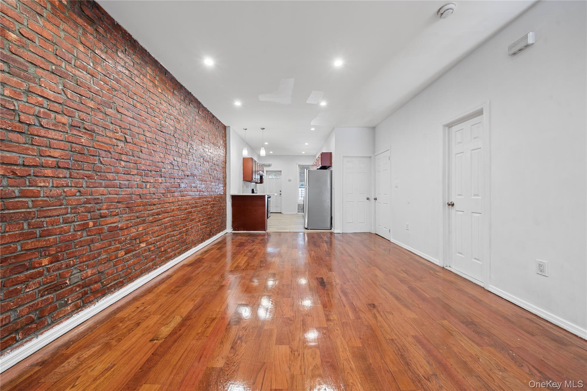 1323 Sutter Avenue Brooklyn, NY 11208 - Photo 11 of 46 a view of an empty room with wooden floor