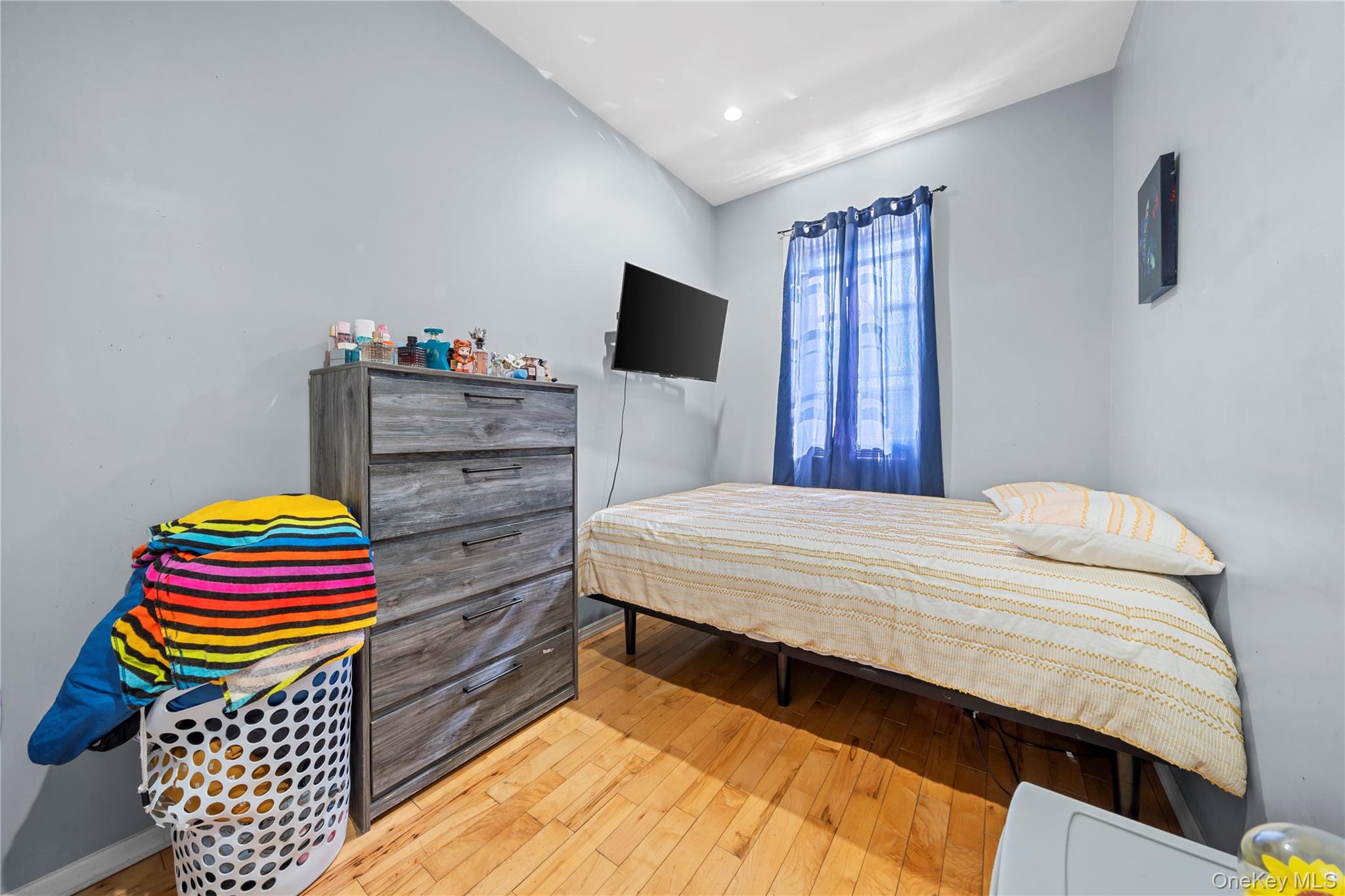 1323 Sutter Avenue Brooklyn, NY 11208 - Photo 26 of 46 a bedroom with a bed and wooden floor