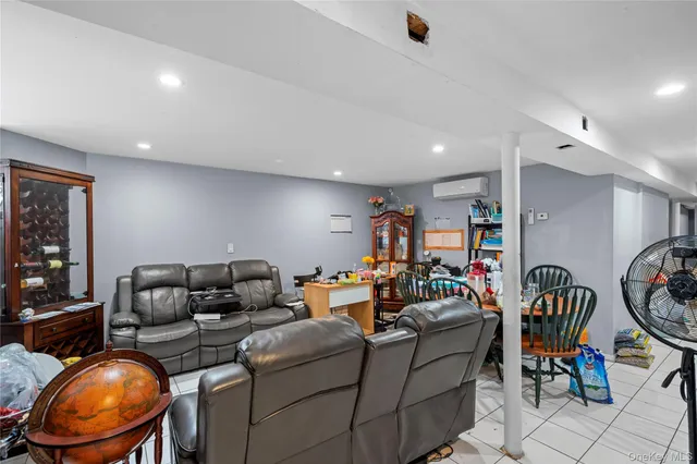 a living room with furniture a air conditioner and a window