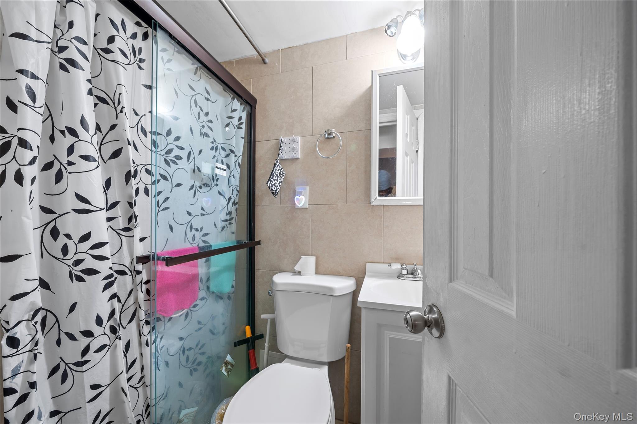 1323 Sutter Avenue Brooklyn, NY 11208 - Photo 32 of 46 a white toilet sitting next to a bathroom sink