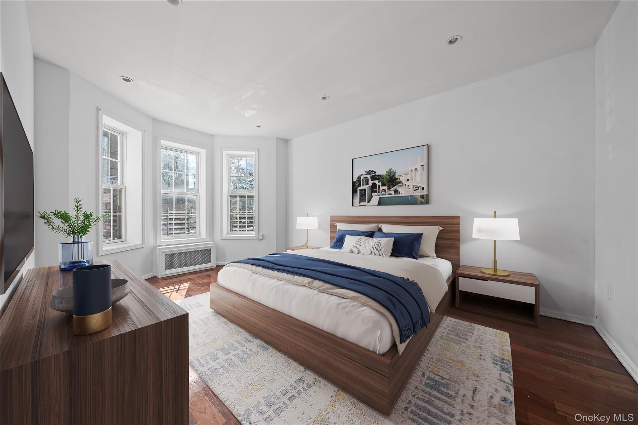 1323 Sutter Avenue Brooklyn, NY 11208 - Photo 4 of 46 a bedroom with a large bed a potted plant and a window