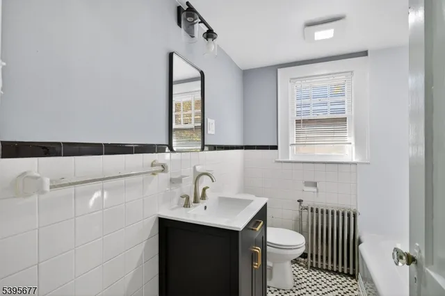 a bathroom with a sink a toilet and mirror