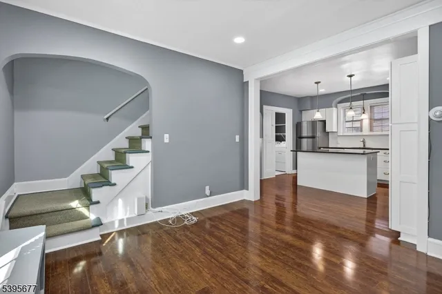 a view of a kitchen with wooden floor and electronic appliances