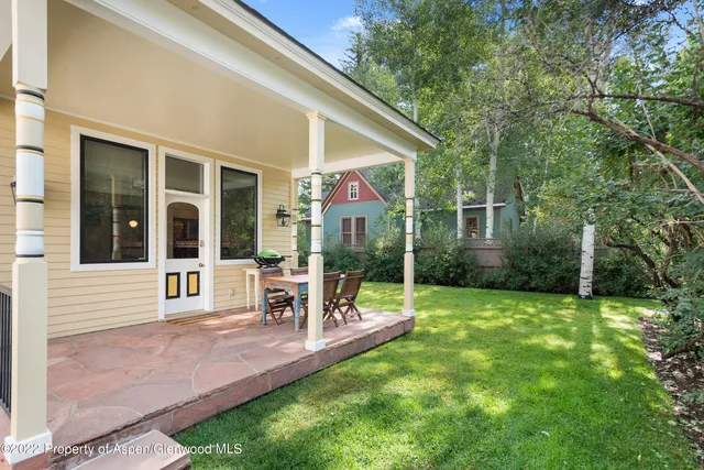 a view of a house with backyard porch and sitting area