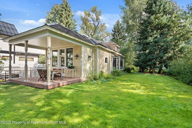 a view of a house with a yard and sitting area