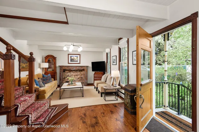 a living room with furniture large window and a fireplace