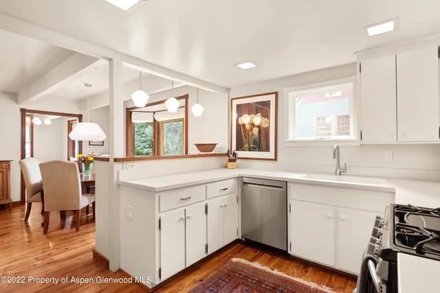 a kitchen with a sink cabinets and window