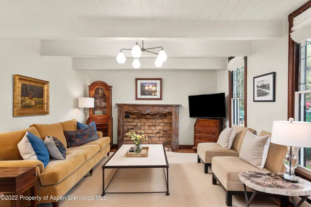 a living room with furniture flat screen tv and a fireplace