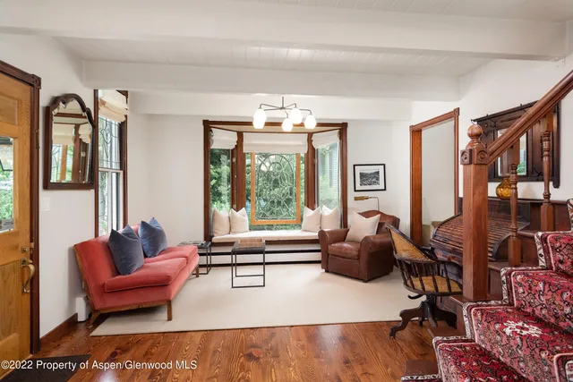 a living room with furniture and large windows