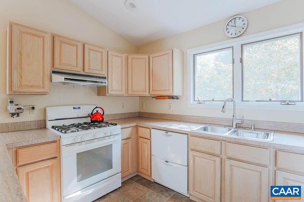 2300 Gobblers Ridge Charlottesville, VA 22902 - Photo 11 of 37 a kitchen with granite countertop a sink cabinets stainless steel appliances and a window