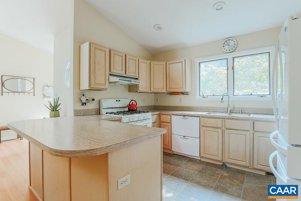 2300 Gobblers Ridge Charlottesville, VA 22902 - Photo 10 of 37 a kitchen with stainless steel appliances granite countertop a sink dishwasher and white cabinets with wooden floor