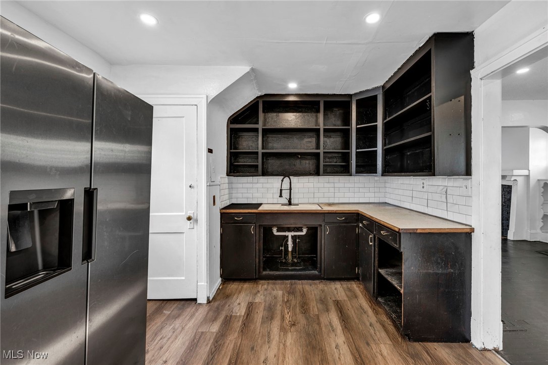 1743 Clarkstone Road Cleveland, OH 44112 - Photo 11 of 24 Kitchen featuring stainless steel fridge, open shelves, dark wood and finished floors