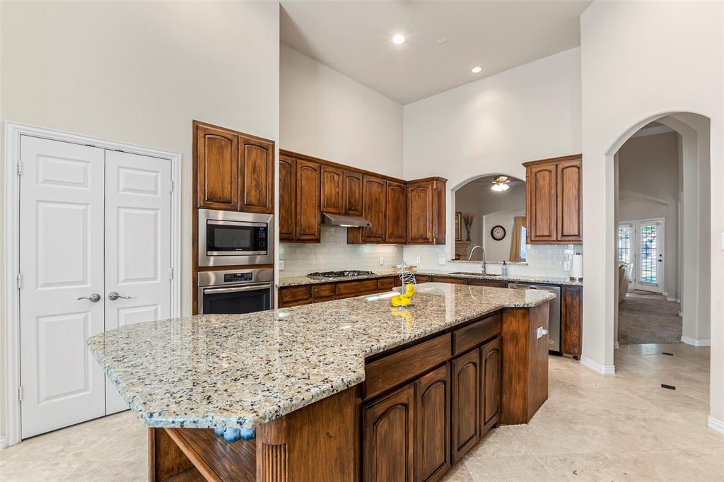 1200 Rio Bravo Way Shady Shores, TX 76208 - Photo 11 of 39 a kitchen with stainless steel appliances granite countertop a sink refrigerator and cabinets