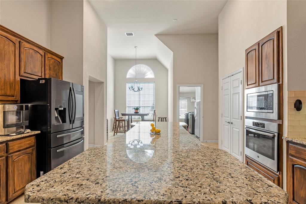 1200 Rio Bravo Way Shady Shores, TX 76208 - Photo 12 of 39 a kitchen with stainless steel appliances kitchen island granite countertop a refrigerator stove and oven