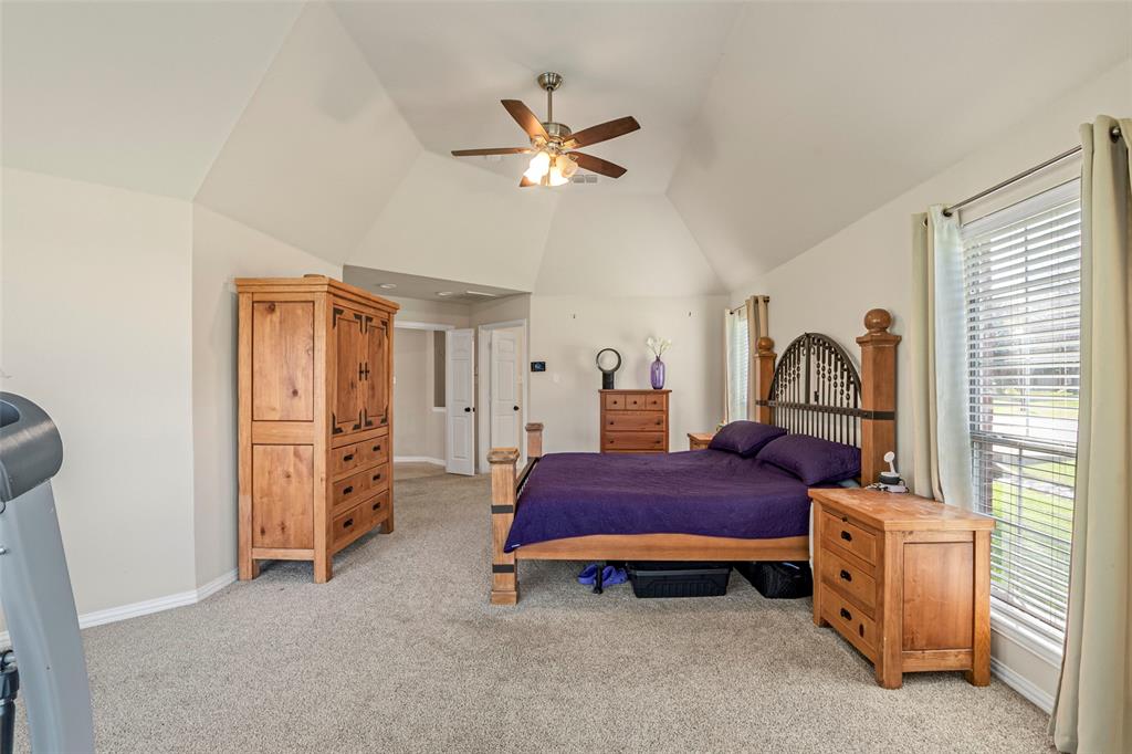 1200 Rio Bravo Way Shady Shores, TX 76208 - Photo 21 of 39 a bedroom with a bed and a chandelier