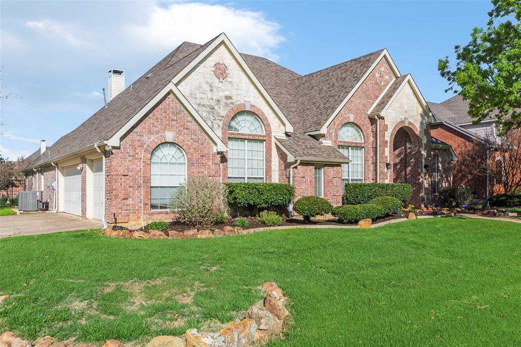 1200 Rio Bravo Way Shady Shores, TX 76208 - Photo 3 of 39 a front view of a house with a garden and plants