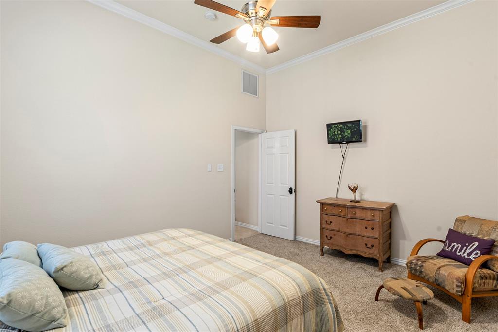 1200 Rio Bravo Way Shady Shores, TX 76208 - Photo 32 of 39 a bedroom with a bed and a chandelier