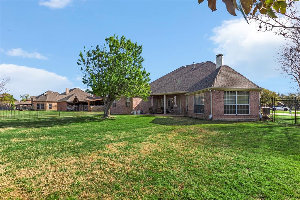 1200 Rio Bravo Way Shady Shores, TX 76208 - Photo 34 of 39 a front view of a house with a garden