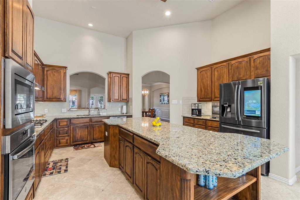 1200 Rio Bravo Way Shady Shores, TX 76208 - Photo 10 of 39 a large kitchen with kitchen island granite countertop a large counter top and stove